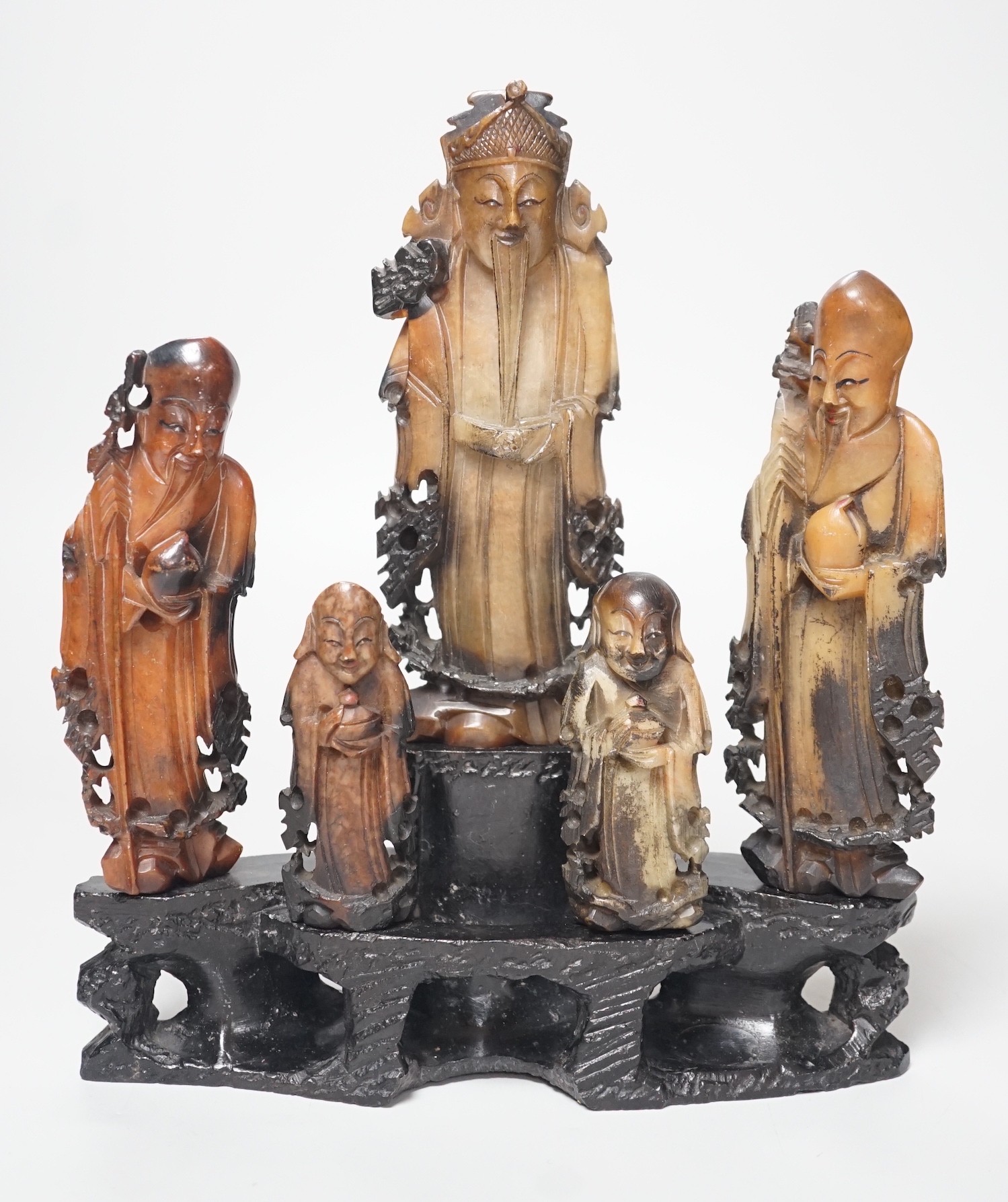 An early 20th century Chinese carved soapstone group of five deities on a rockwork base, 23cm